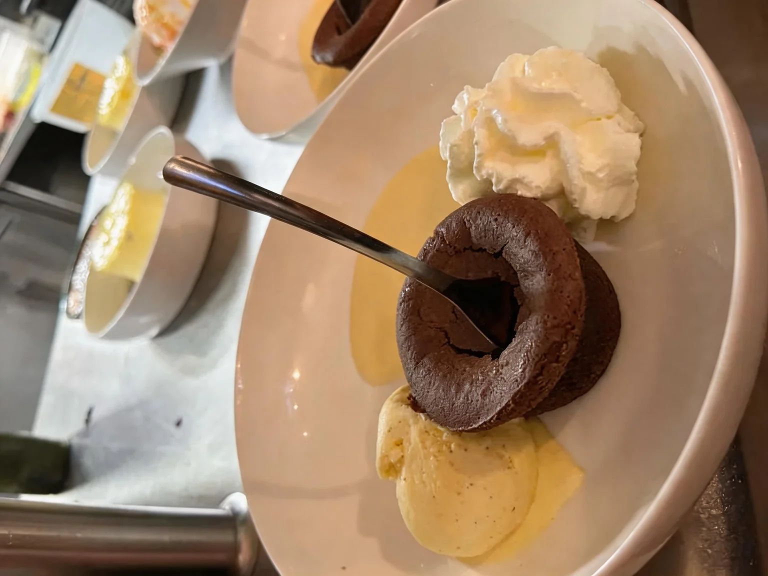 Chocolate fondant, with a dollop of whipped cream and a scoop of ice cream.