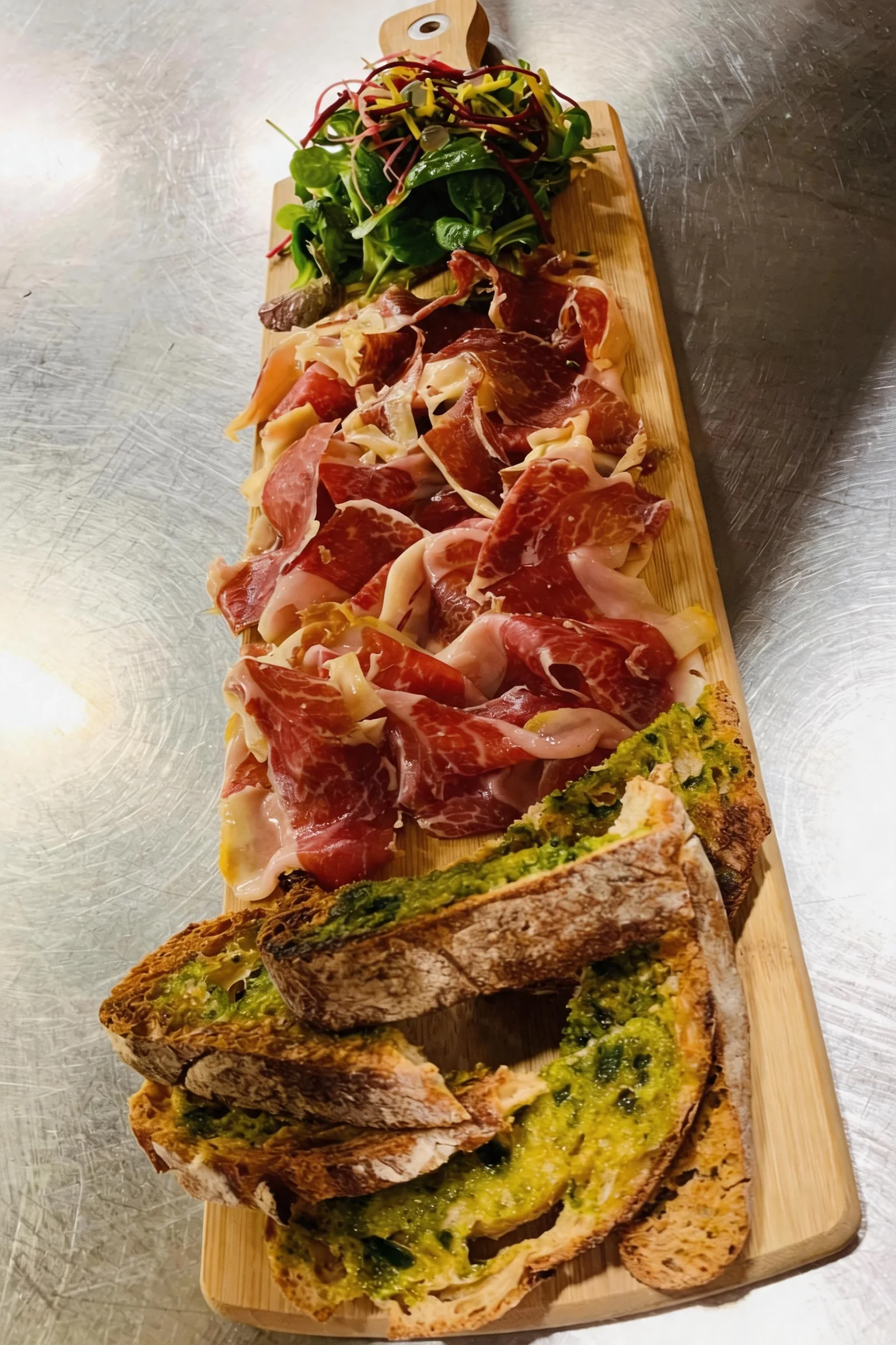 Board of Italian charcuterie, salad and grilled toasts.